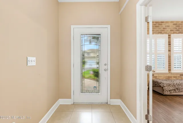 a view of bedroom with window and front door