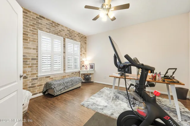 a bedroom with furniture and a wooden floor