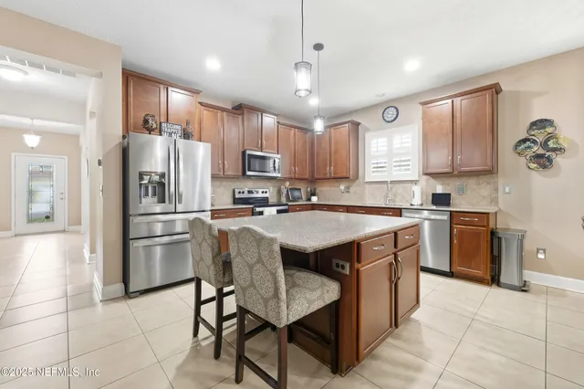 a kitchen with a refrigerator a sink and cabinets