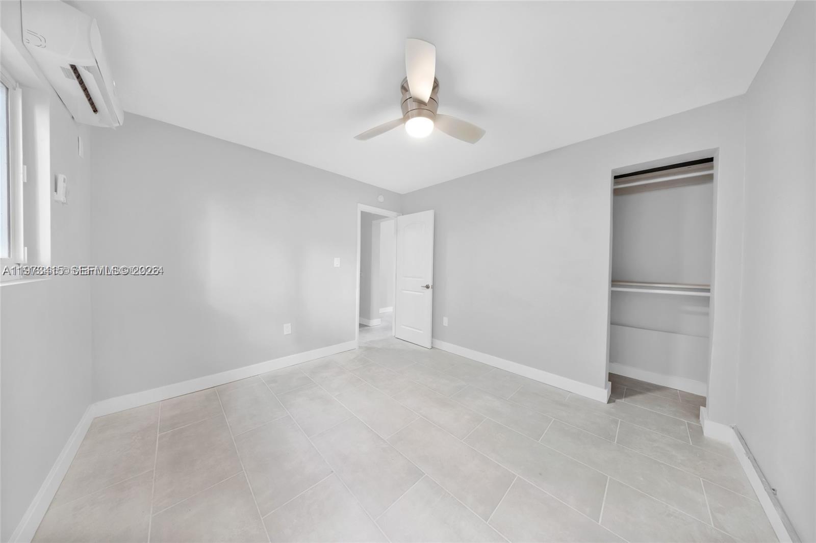 1150 Northwest 1st Place, Unit 2 Miami, FL 33136 - Photo 11 of 19 an empty room with closet and windows