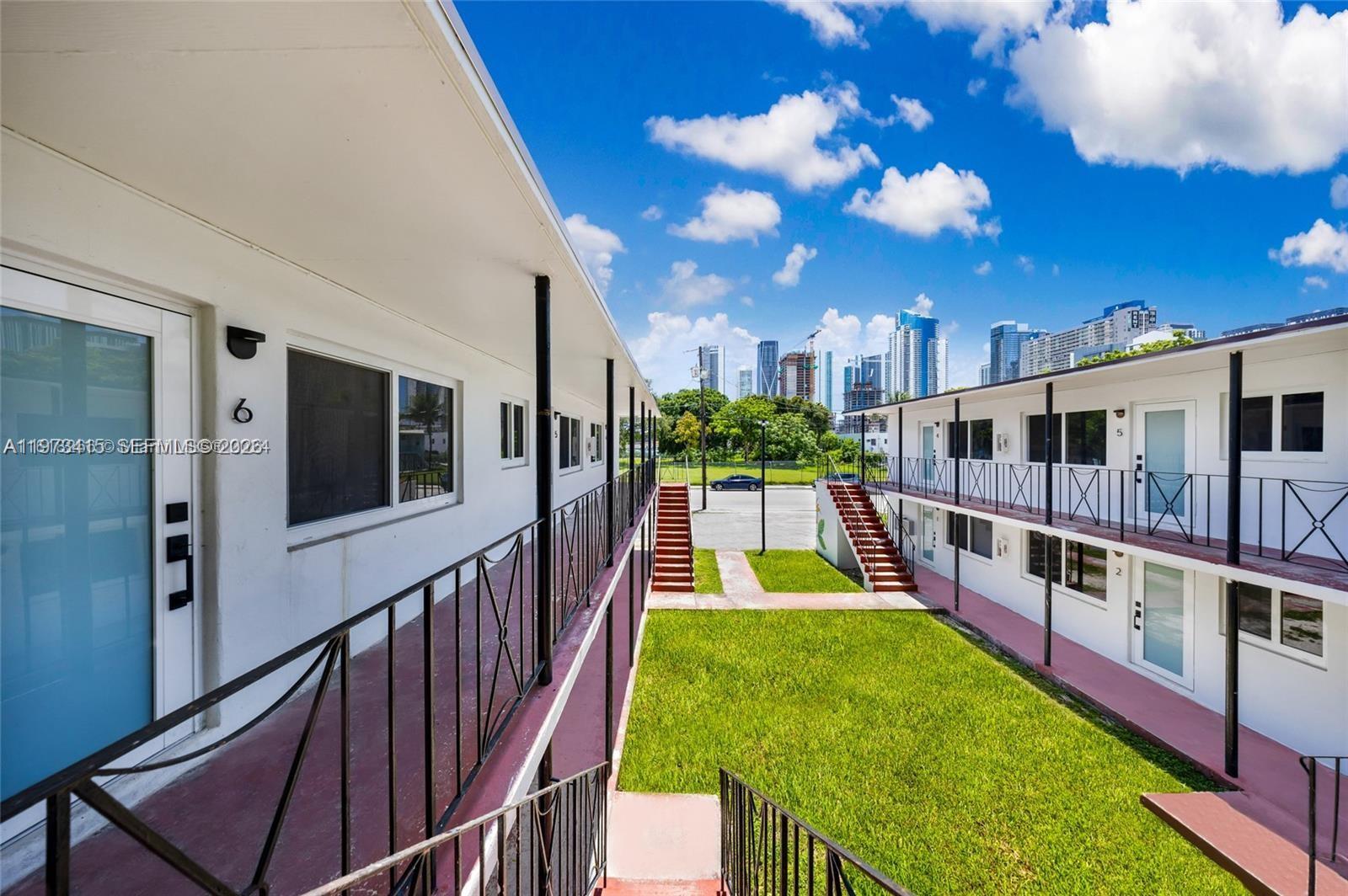 1150 Northwest 1st Place, Unit 2 Miami, FL 33136 - Photo 4 of 19 a view of a house with swimming pool and sitting area