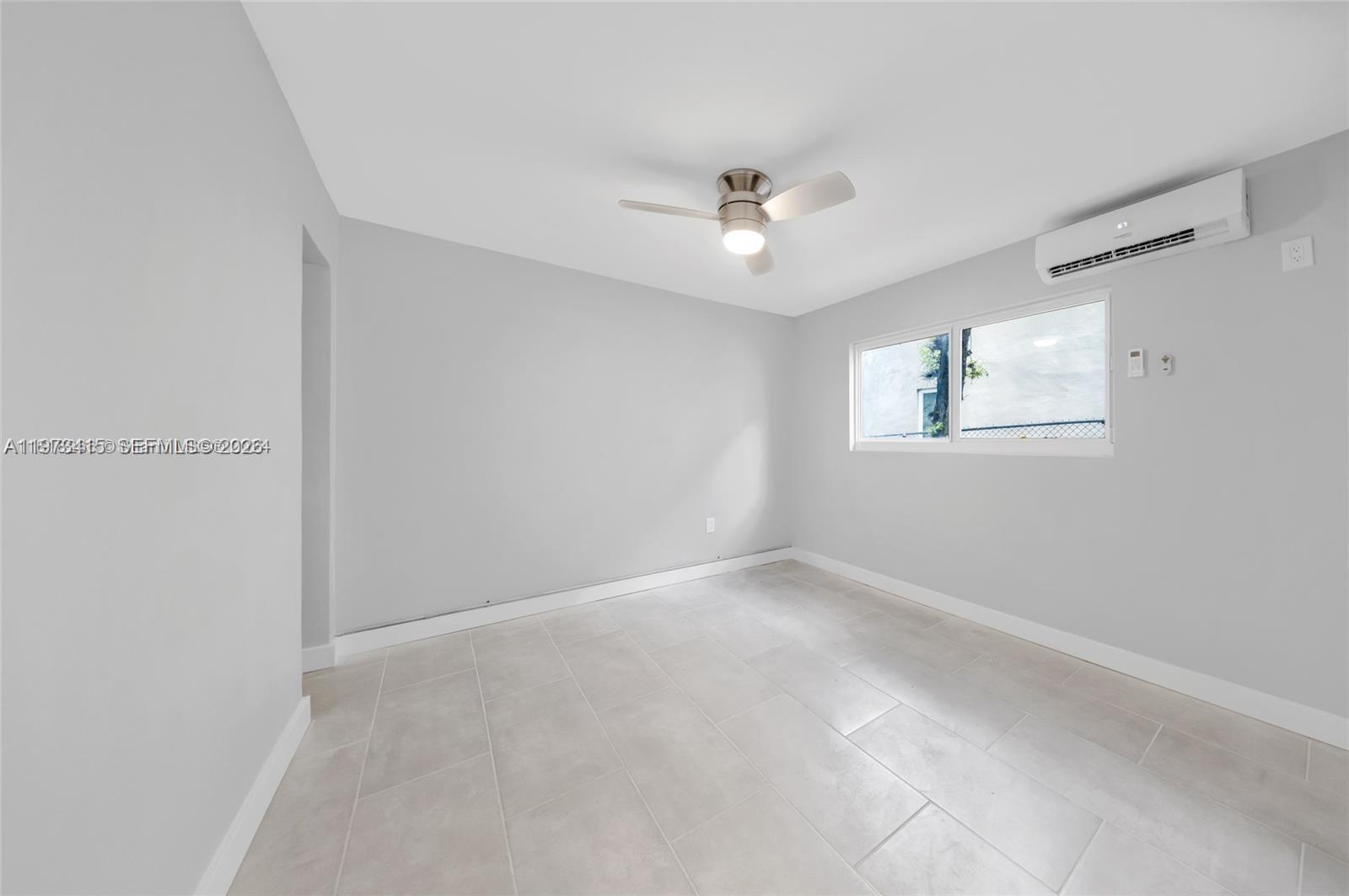 1150 Northwest 1st Place, Unit 2 Miami, FL 33136 - Photo 6 of 19 a view of an empty room with a window