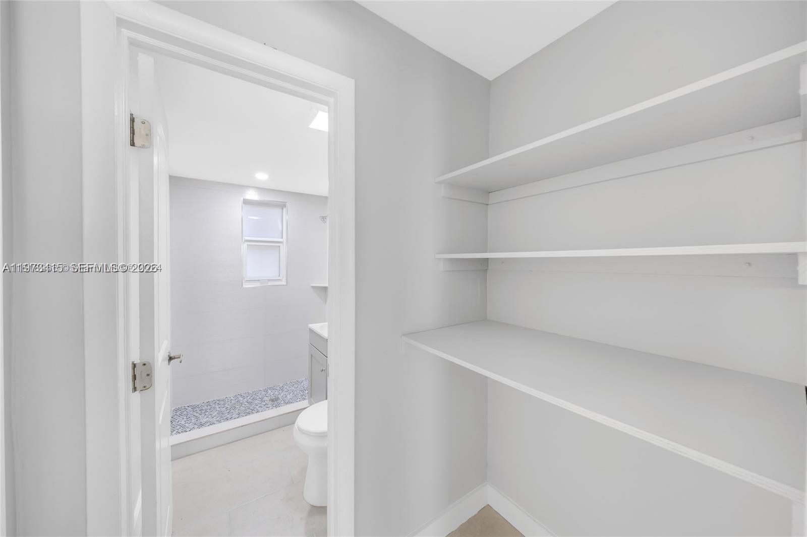 1150 Northwest 1st Place, Unit 2 Miami, FL 33136 - Photo 8 of 19 a view of an empty walk in closet