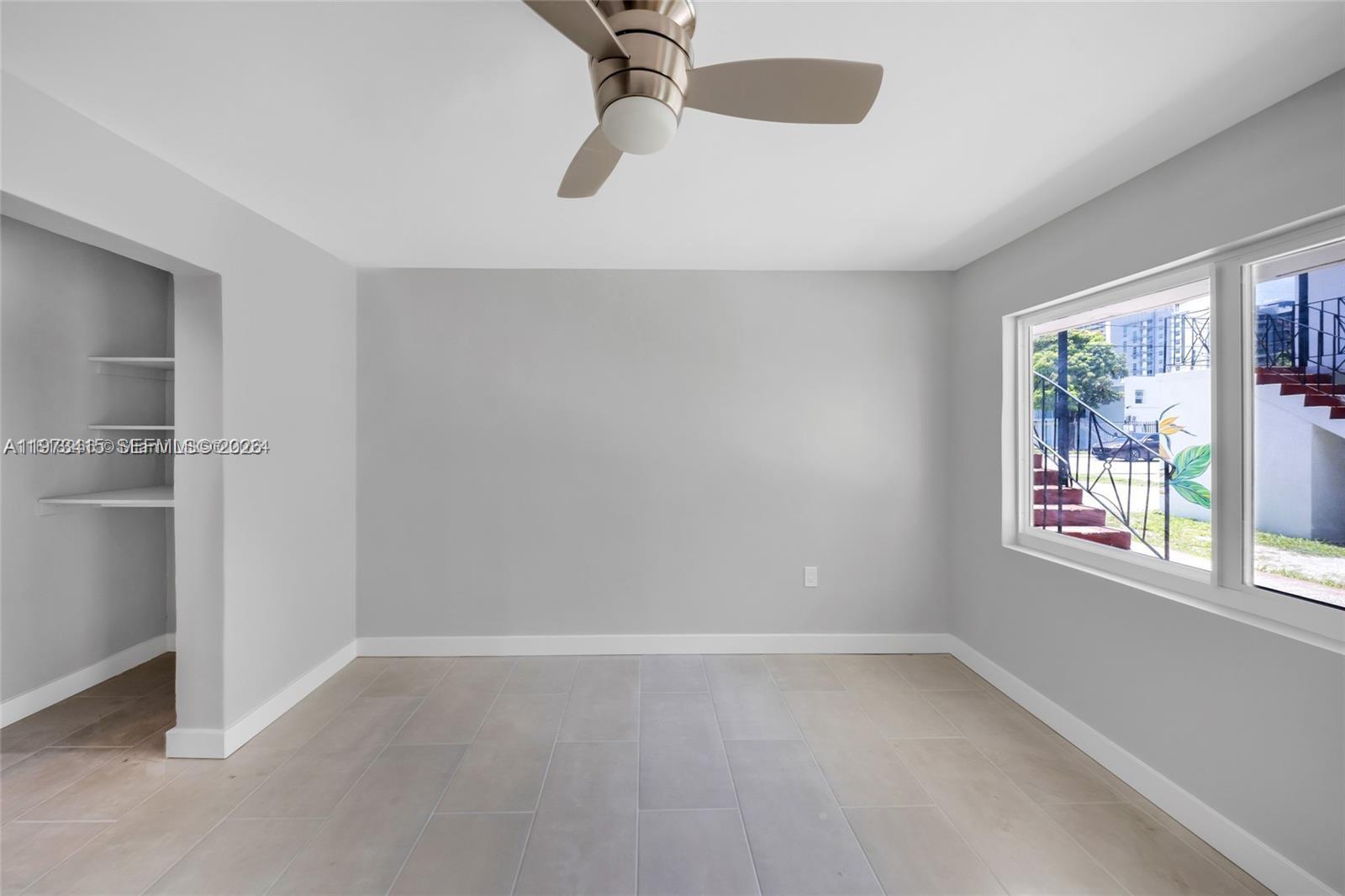 1150 Northwest 1st Place, Unit 2 Miami, FL 33136 - Photo 10 of 19 a view of an empty room with a window