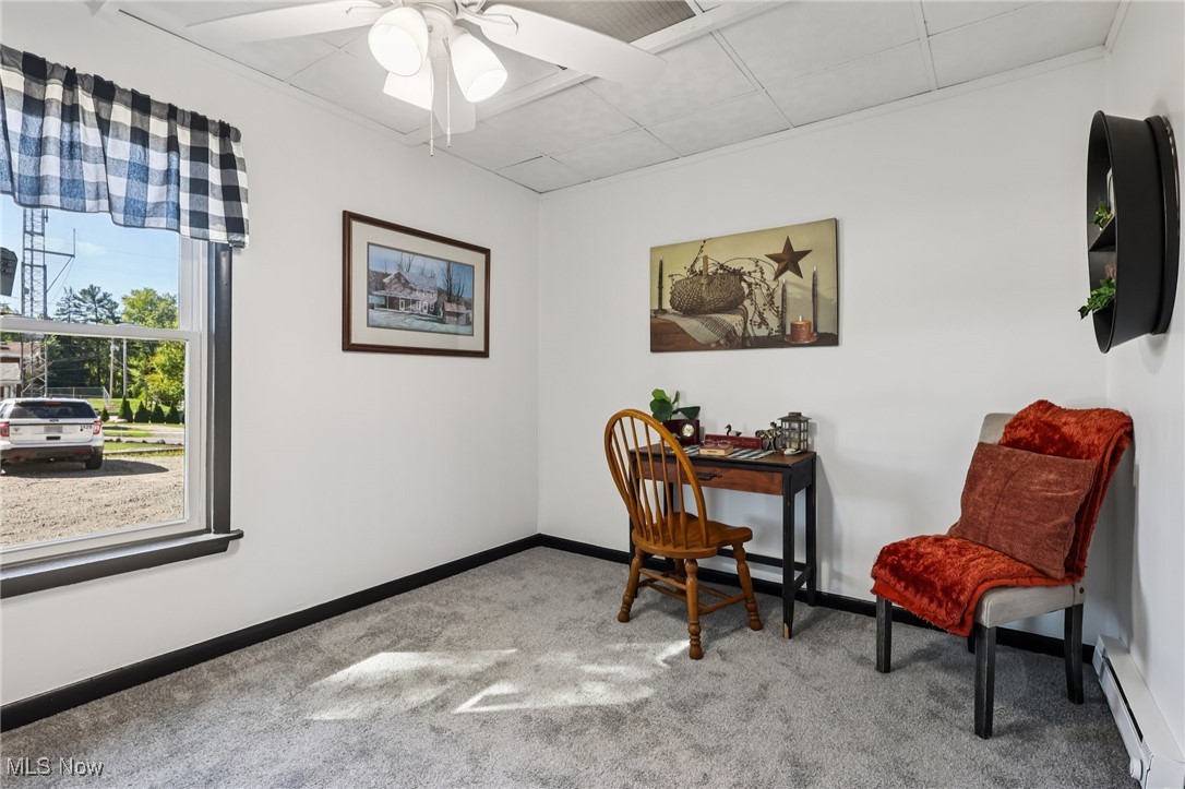 1743 West Prospect Road Ashtabula, OH 44004 - Photo 34 of 43 Office with a baseboard heating unit, light colored carpet, ceiling fan, and a drop ceiling