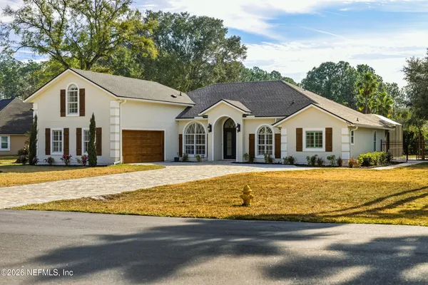 a house with swimming pool in front of it