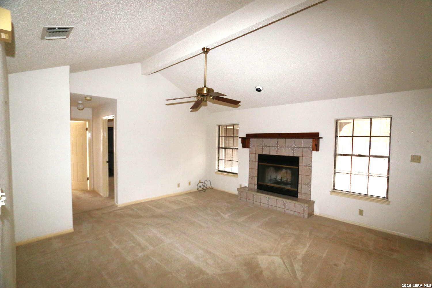 802 Athens Street Castroville, TX 78009 - Photo 12 of 44 a view of a livingroom with a fireplace and window