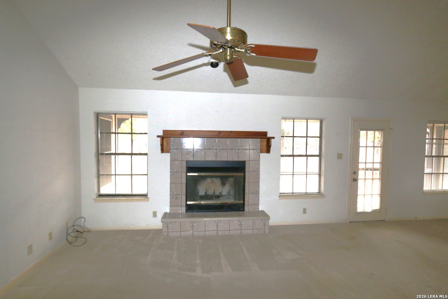 802 Athens Street Castroville, TX 78009 - Photo 16 of 44 an empty room with windows and fireplace
