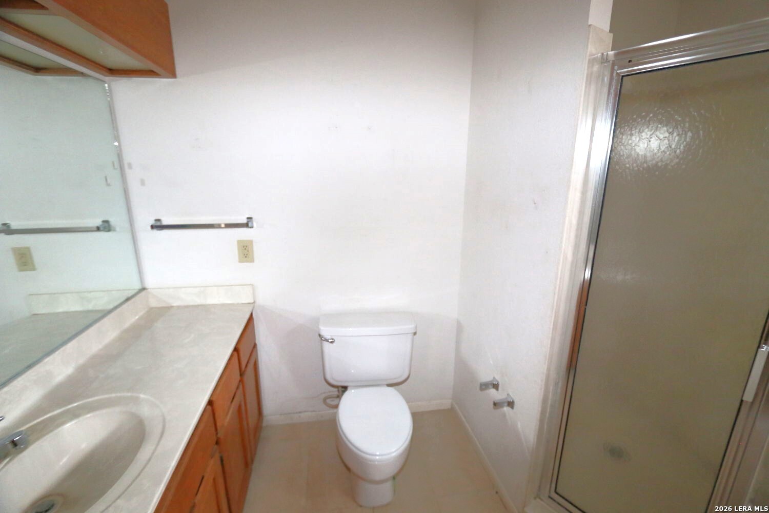 802 Athens Street Castroville, TX 78009 - Photo 24 of 44 a bathroom with a granite countertop toilet and a sink