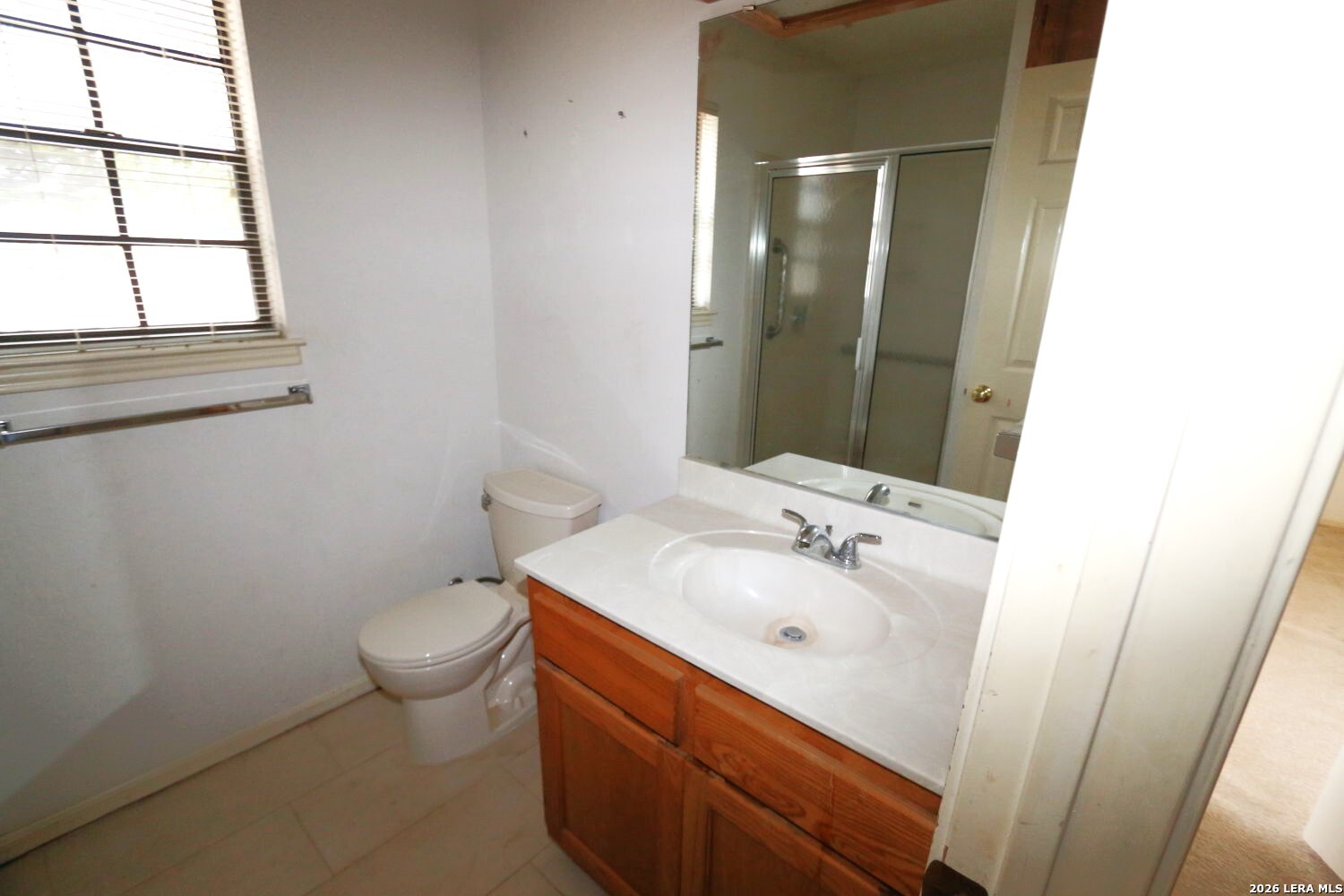 802 Athens Street Castroville, TX 78009 - Photo 27 of 44 a bathroom with a sink and a mirror