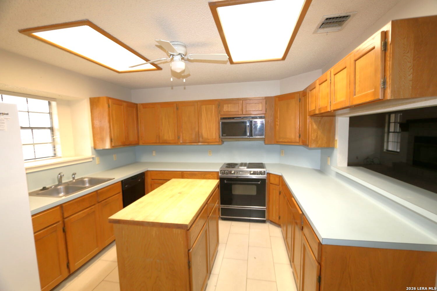 802 Athens Street Castroville, TX 78009 - Photo 29 of 44 a kitchen with stainless steel appliances granite countertop a sink stove and cabinets