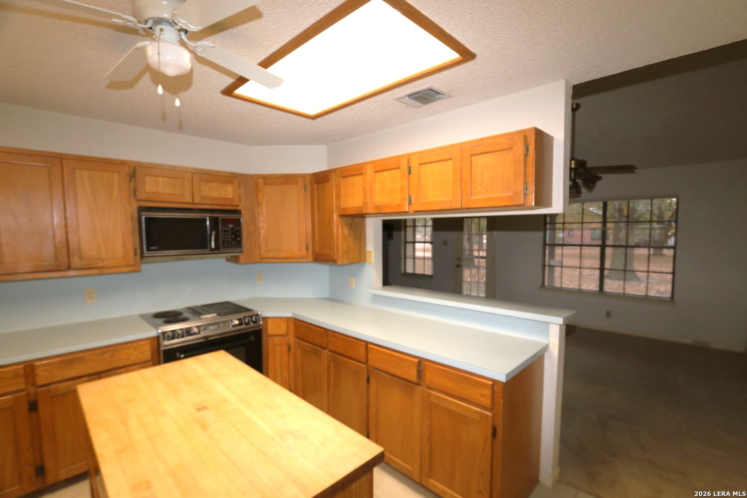 802 Athens Street Castroville, TX 78009 - Photo 32 of 44 a kitchen with stainless steel appliances granite countertop a sink cabinets and wooden floor