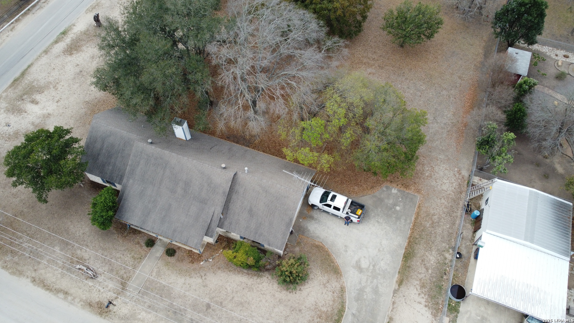 802 Athens Street Castroville, TX 78009 - Photo 38 of 44 an aerial view of a house with outdoor space and trees all around