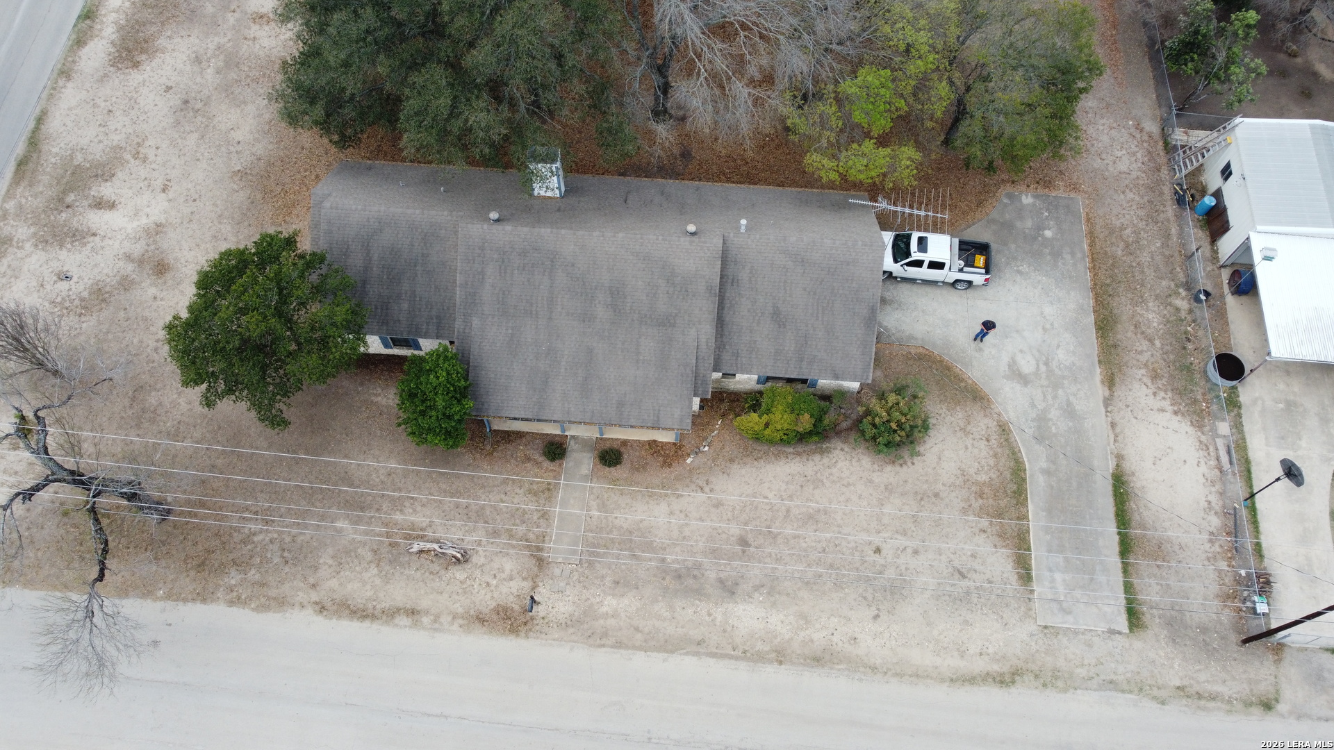 802 Athens Street Castroville, TX 78009 - Photo 42 of 44 an aerial view of a house with a yard and a wooden fence