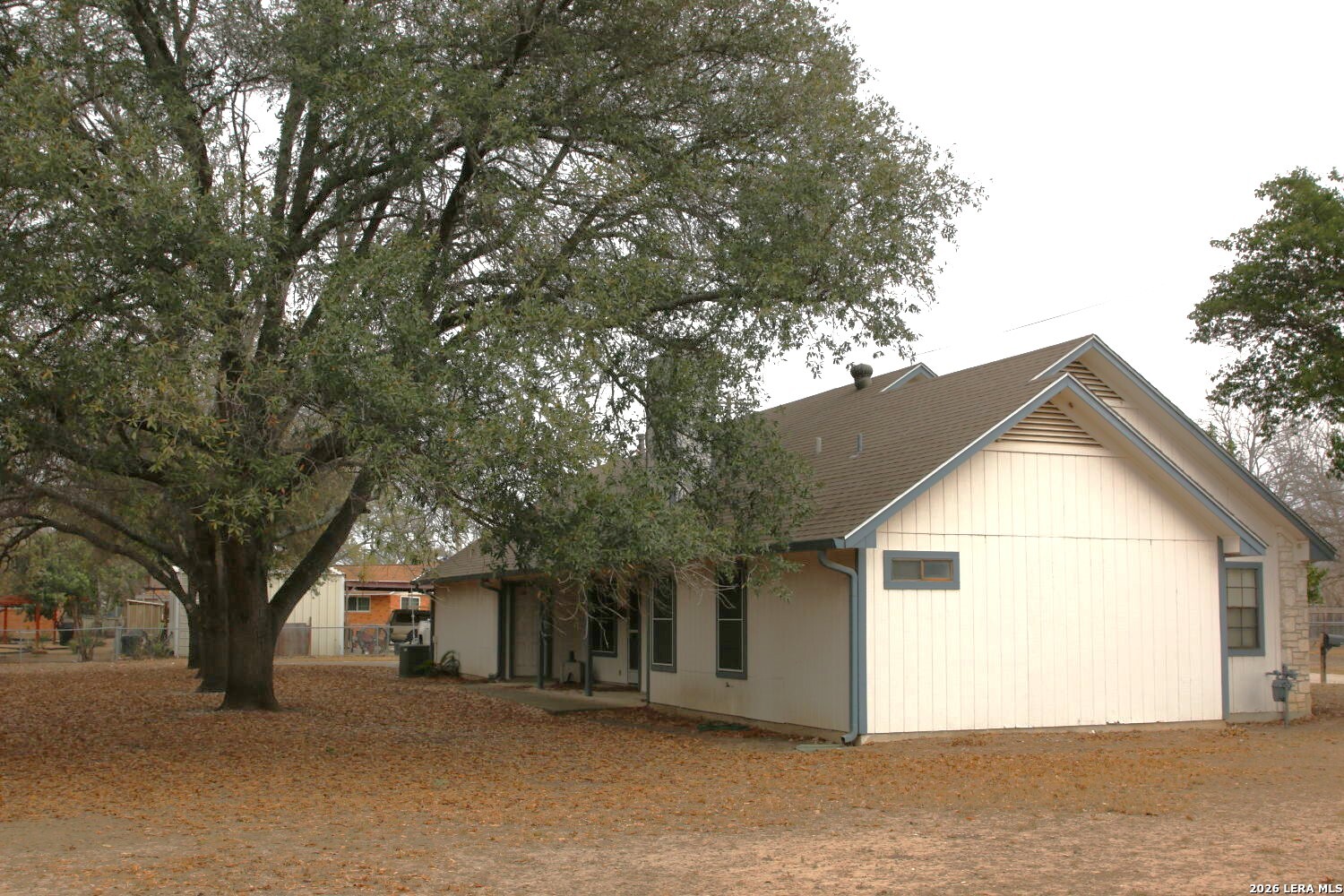 802 Athens Street Castroville, TX 78009 - Photo 7 of 44 a view of a house with a large tree and a yard