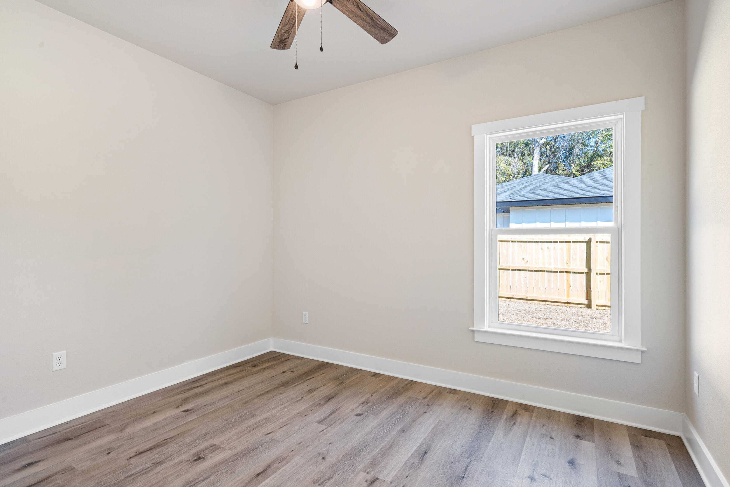 873 Brett Street South Crestview, FL 32539 - Photo 24 of 50 an empty room with a window and wooden floor