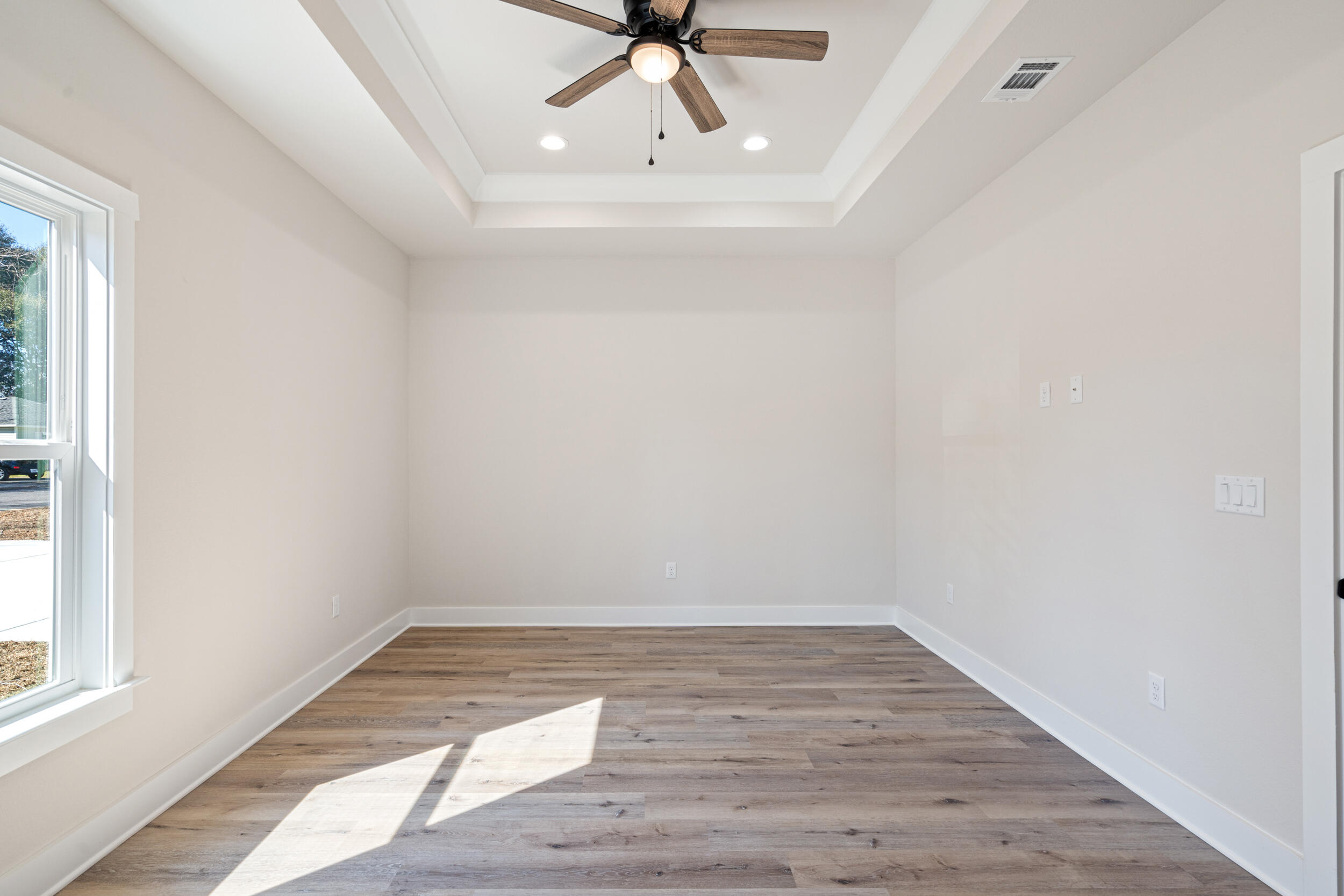 873 Brett Street South Crestview, FL 32539 - Photo 32 of 50 a view of an empty room with wooden floor and a window