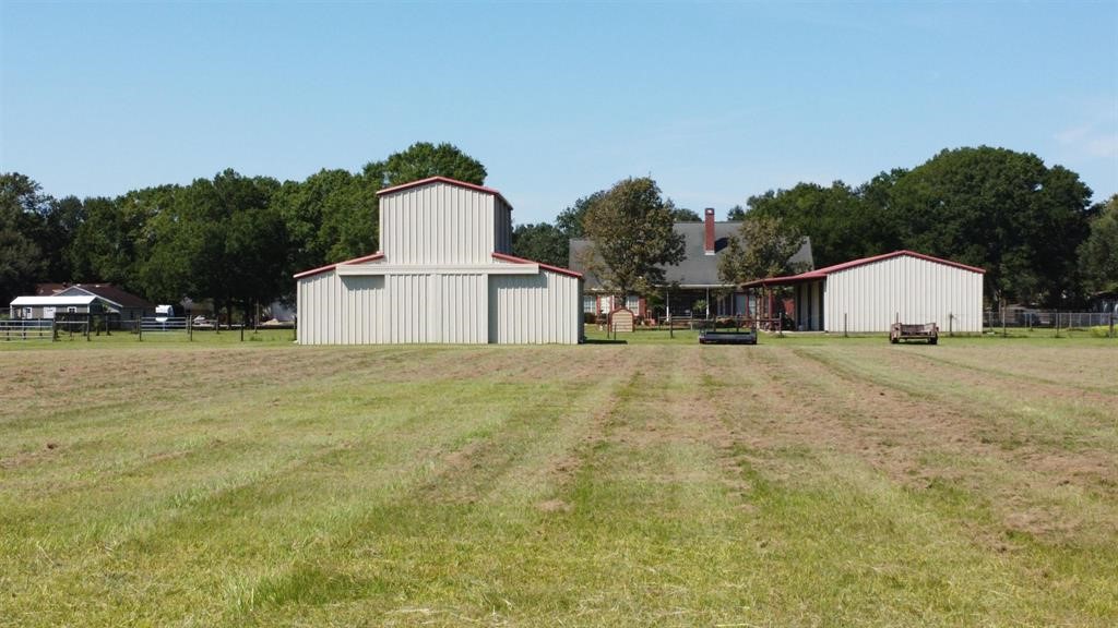 1655 Wooten Road Beaumont, TX 77707 - Photo 41 of 46 a view of a white house with a yard