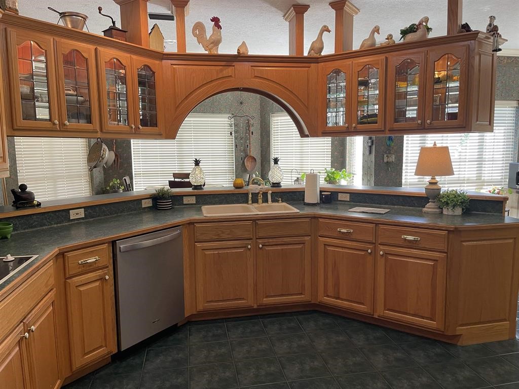 1655 Wooten Road Beaumont, TX 77707 - Photo 10 of 46 a kitchen with stainless steel appliances granite countertop a sink and cabinets