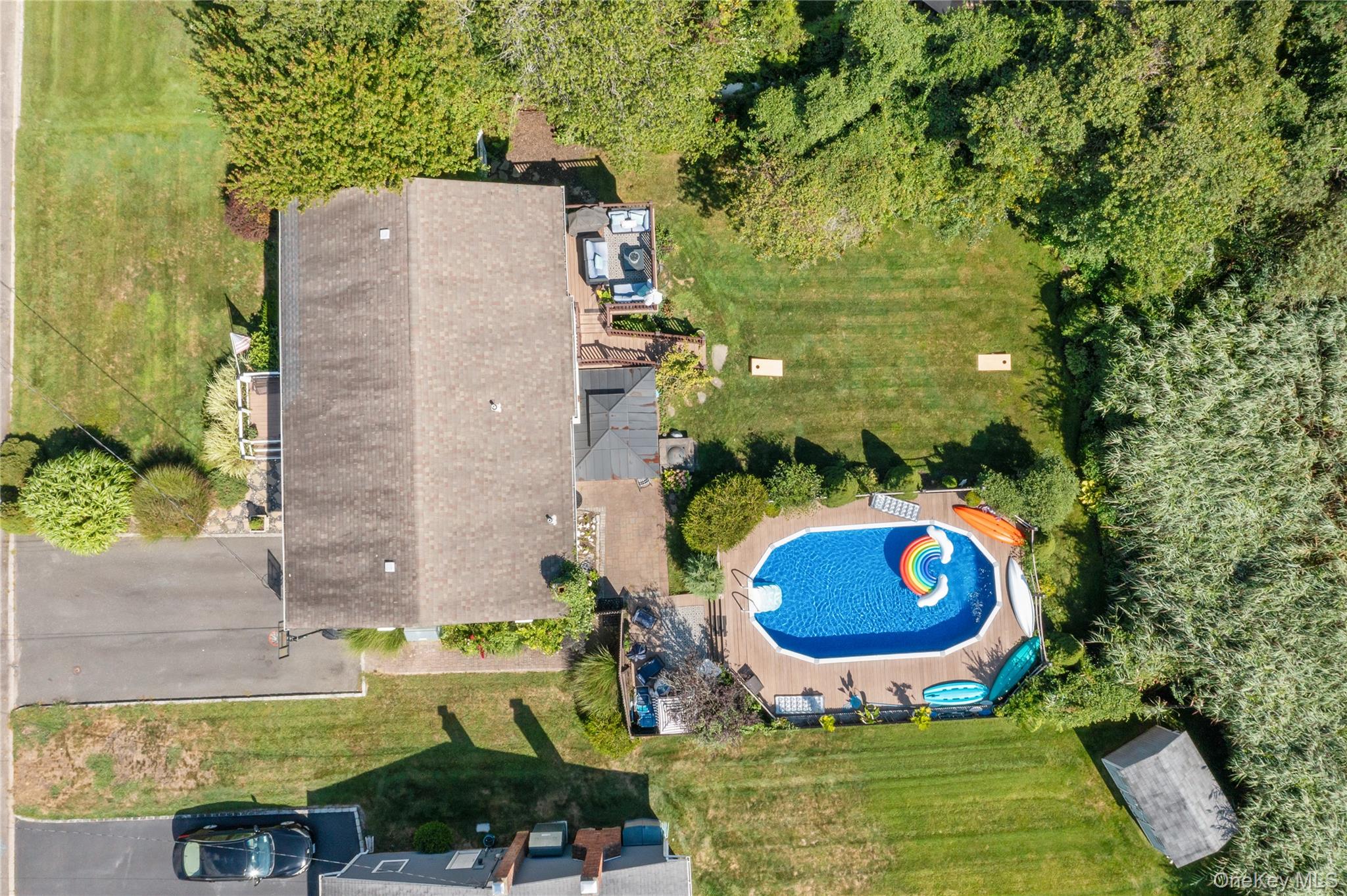 116 Cross Road Oakdale, NY 11769 - Photo 20 of 26 an aerial view of a house with a swimming pool and garden