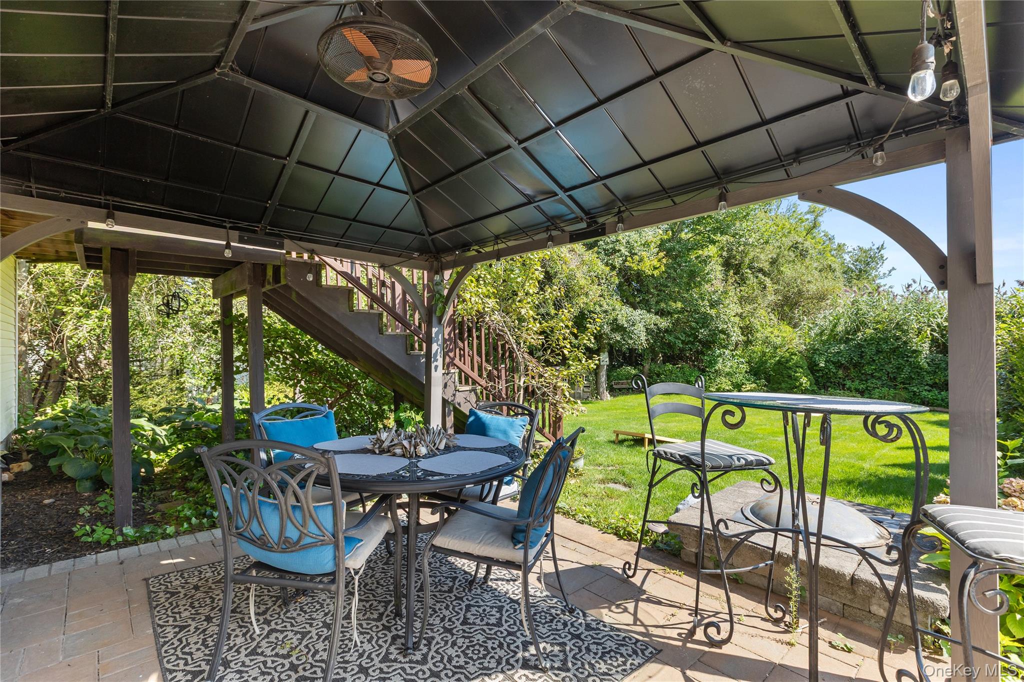116 Cross Road Oakdale, NY 11769 - Photo 23 of 26 a view of chairs and table in patio with a backyard