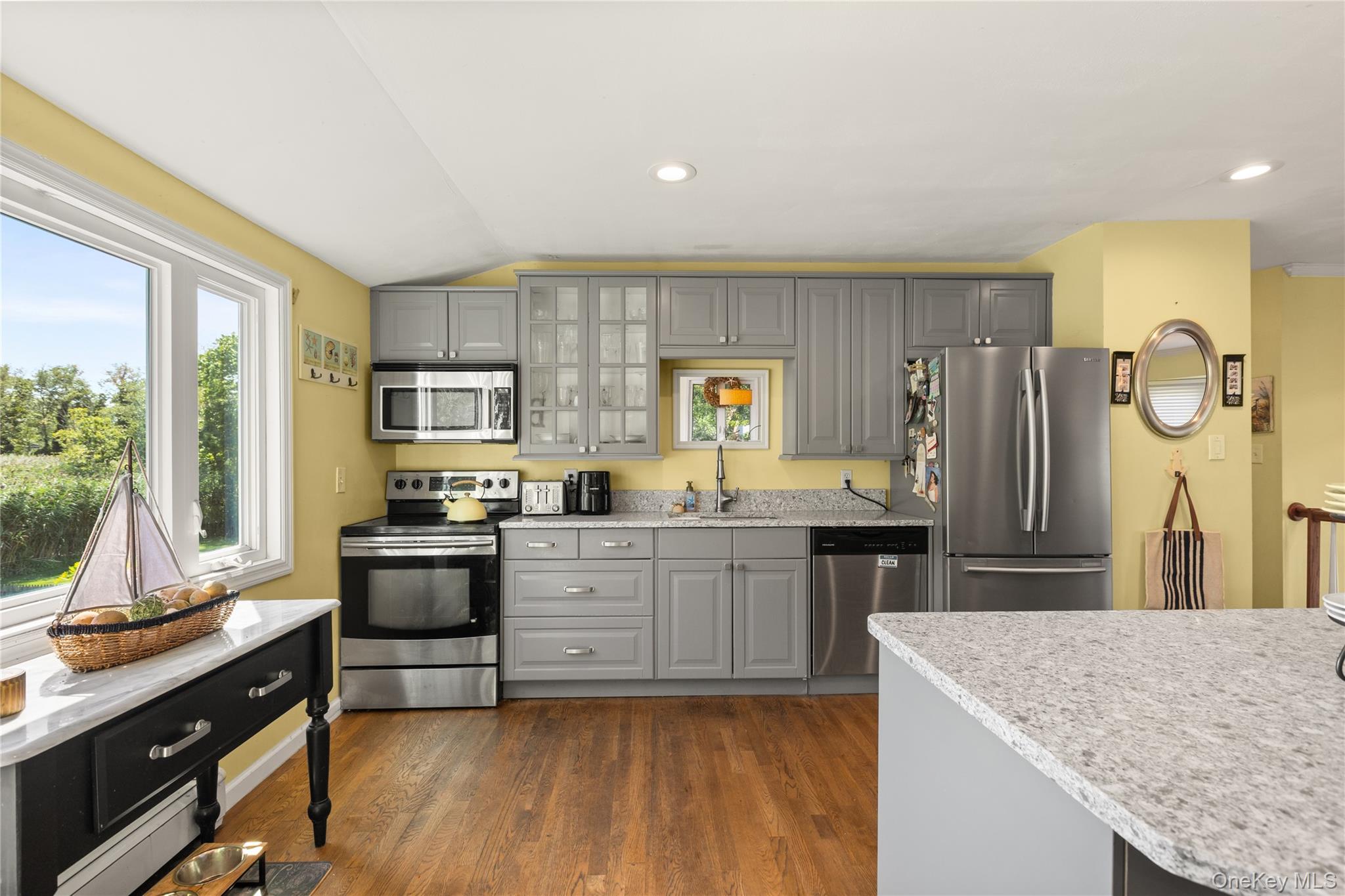 116 Cross Road Oakdale, NY 11769 - Photo 3 of 26 a kitchen with stainless steel appliances granite countertop sink refrigerator dining table and chairs