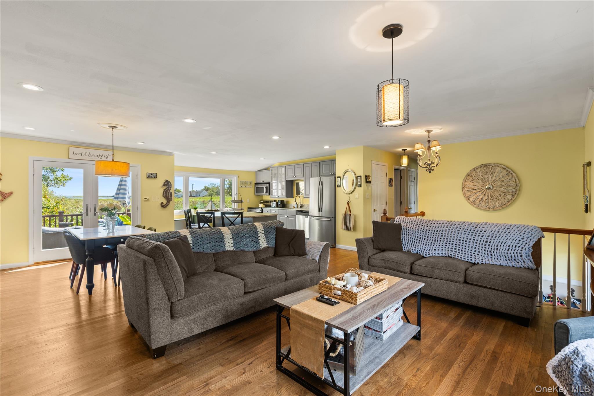 116 Cross Road Oakdale, NY 11769 - Photo 7 of 26 a living room with furniture kitchen view and a wooden floor
