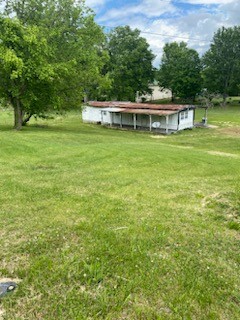 a view of a green field with sitting area