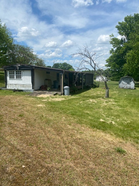 4309 Joe Peay Cemetery Road Spring Hill, TN 37174 - Photo 2 of 8 a backyard of a house with yard and garage