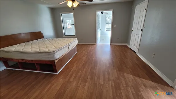a view of a room with window and a ceiling fan