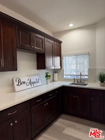 a kitchen with stainless steel appliances granite countertop a sink dishwasher stove and cabinets