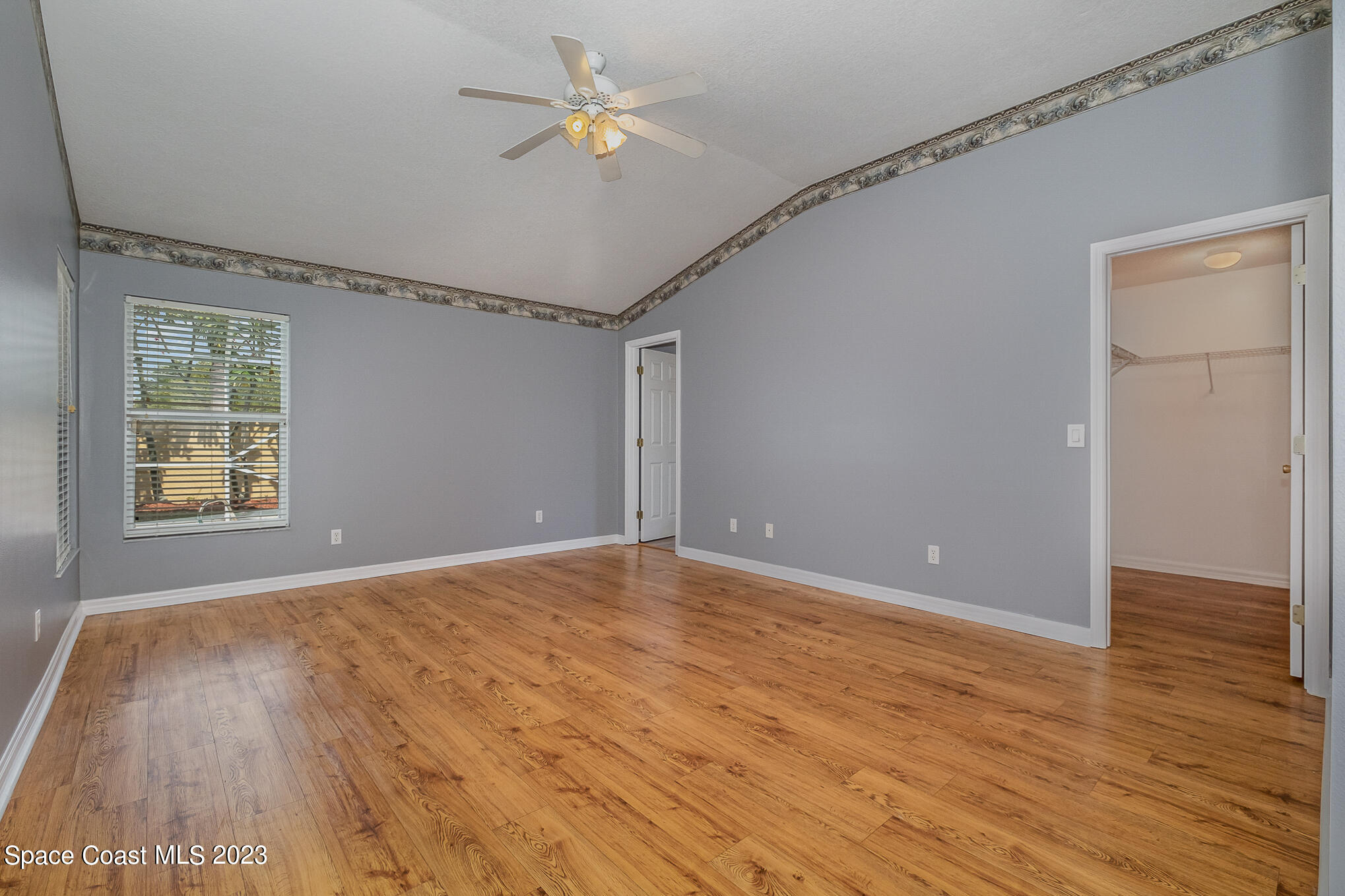 3910 La Flor Drive Rockledge, FL 32955 - Photo 13 of 24 a view of an empty room with a window and wooden floor
