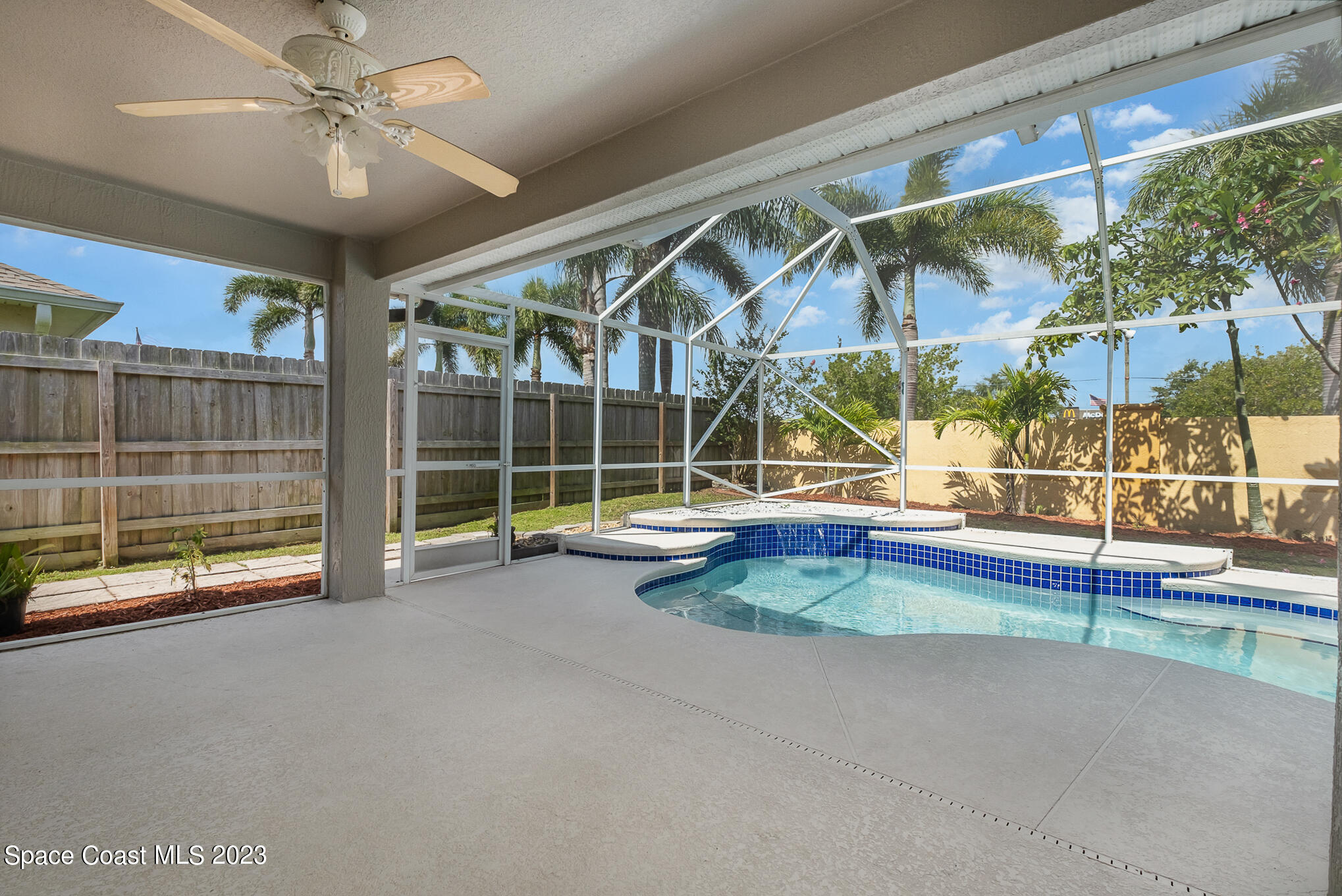 3910 La Flor Drive Rockledge, FL 32955 - Photo 22 of 24 a view of an empty room with a floor to ceiling window and stairs