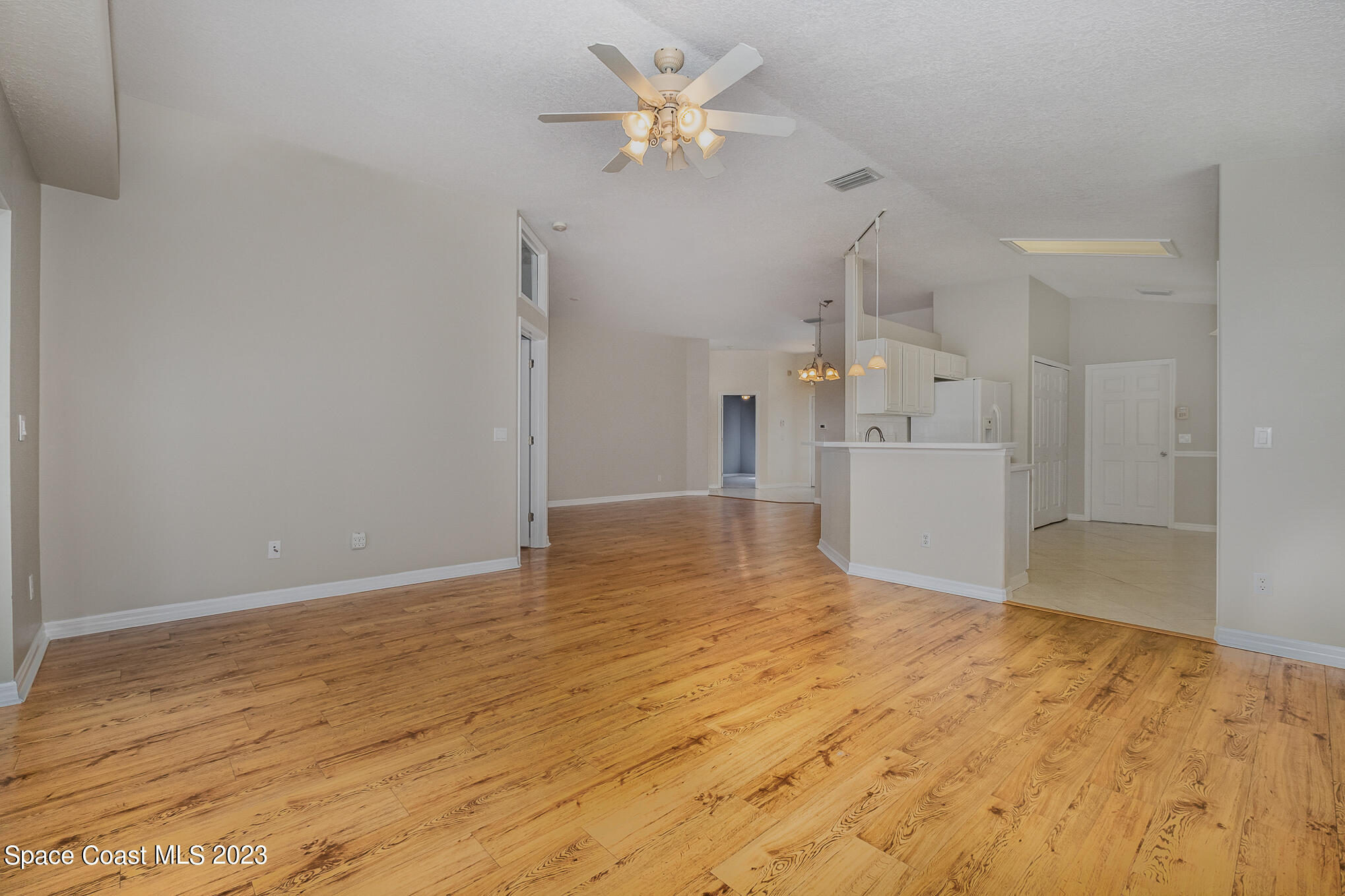 3910 La Flor Drive Rockledge, FL 32955 - Photo 6 of 24 a view of empty room with wooden floor and ceiling fan