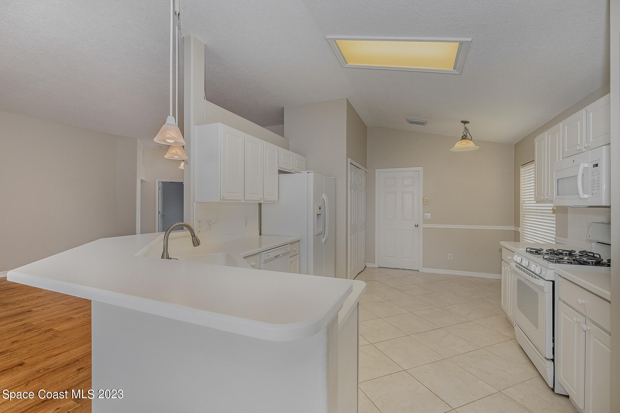3910 La Flor Drive Rockledge, FL 32955 - Photo 8 of 24 a kitchen with stainless steel appliances a stove a sink and a refrigerator