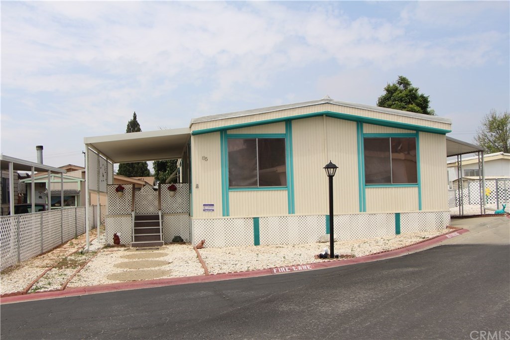 4041 Pedley, Unit 85 Riverside, CA 92509 - Photo 1 of 1 a front view of a house with a yard