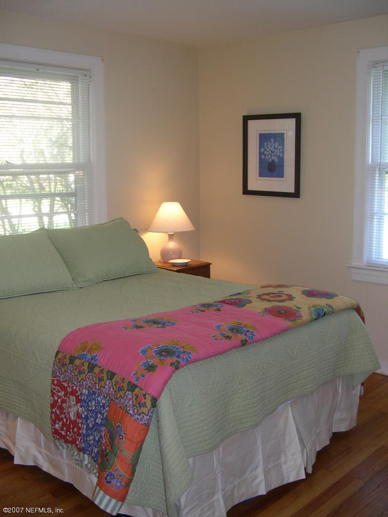 4145 London Road Jacksonville, FL 32207 - Photo 5 of 12 a bedroom with a bed and a couch