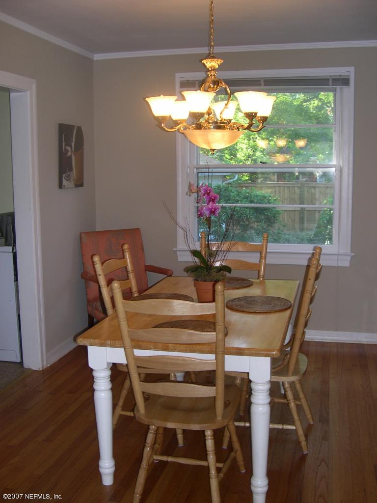 4145 London Road Jacksonville, FL 32207 - Photo 6 of 12 a view of a dining room with furniture a chandelier window and outside view