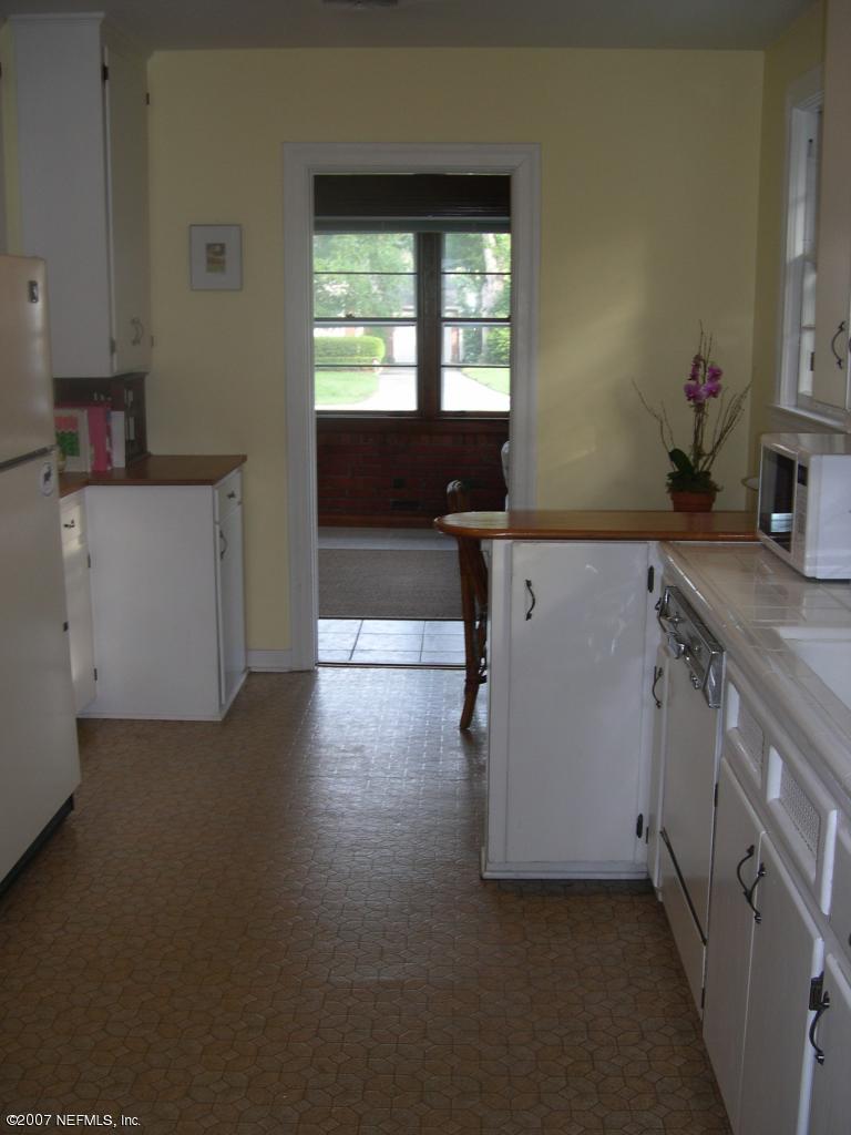 4145 London Road Jacksonville, FL 32207 - Photo 9 of 12 a kitchen with a sink stove and cabinets