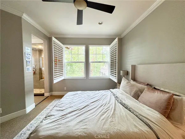 a bedroom with a large bed and a large window