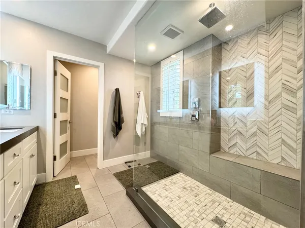 a bathroom with a granite countertop sink a toilet and shower