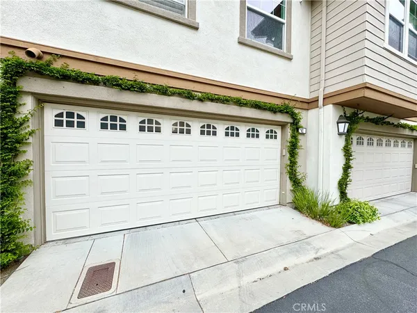 a front view of a house with a yard and potted plants