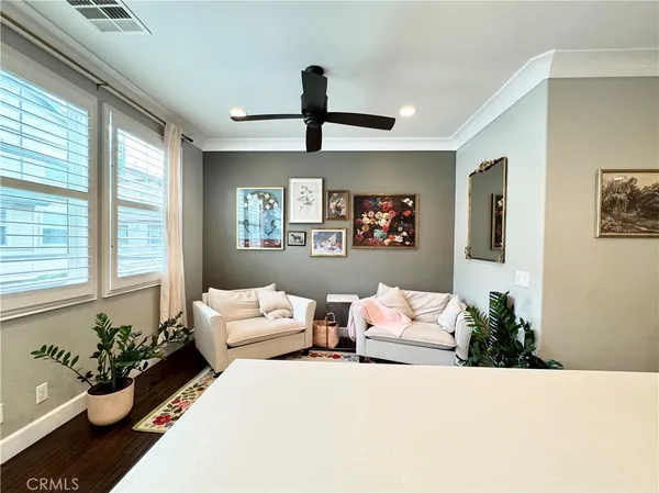 a bedroom with furniture and a large window