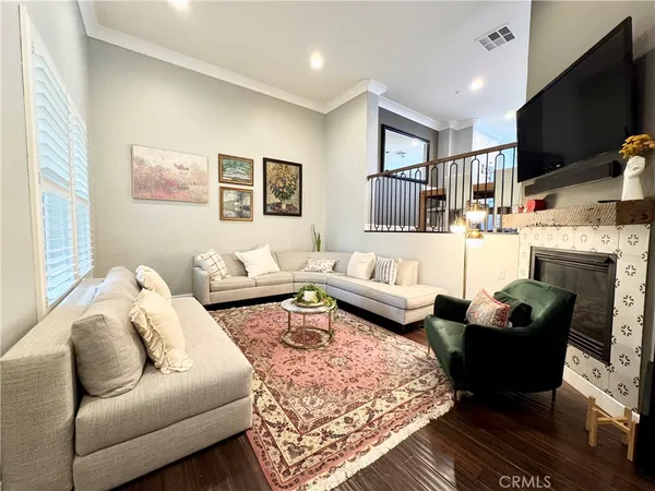 a living room with furniture fireplace and flat screen tv