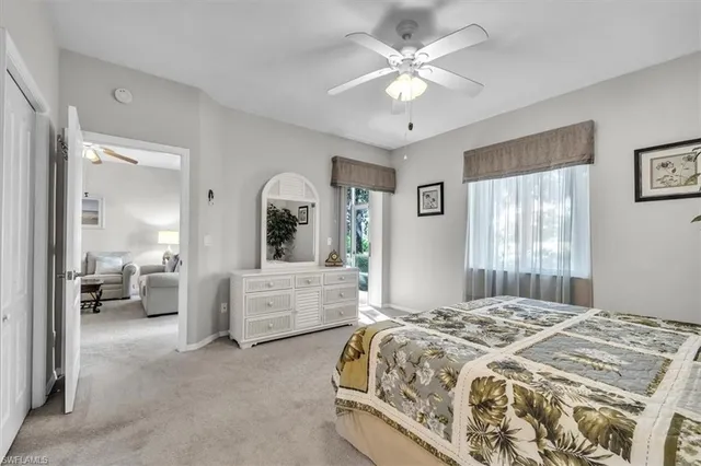 a spacious bedroom with a large bed and a chandelier