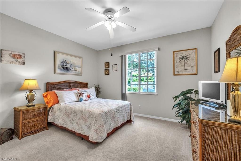 8075 Tiger Cove, Unit 1706 Naples, FL 34113 - Photo 28 of 50 a bedroom with a bed dresser and a window