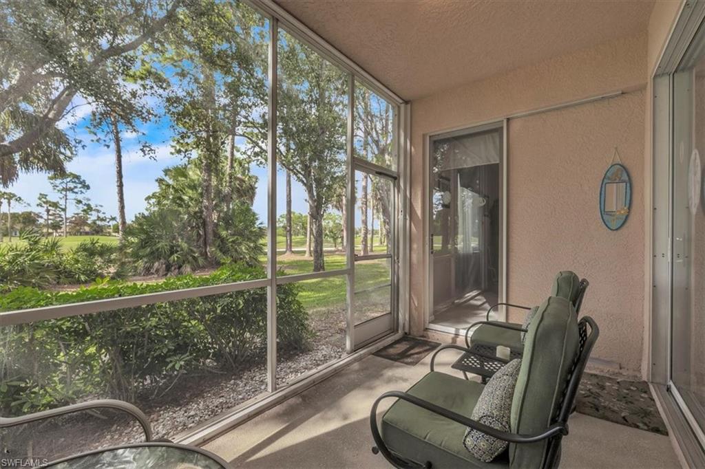 8075 Tiger Cove, Unit 1706 Naples, FL 34113 - Photo 35 of 50 a view of a balcony with chair and glass door