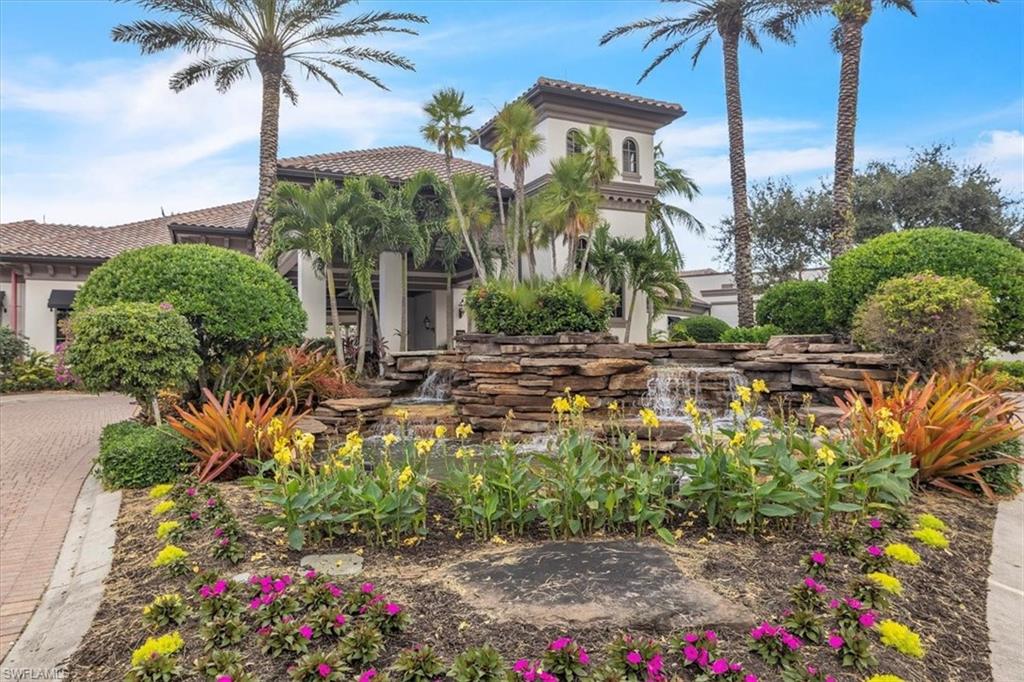 8075 Tiger Cove, Unit 1706 Naples, FL 34113 - Photo 46 of 50 a couple of flower plants in front of yellow house