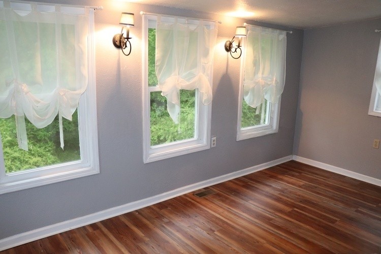 209 Church Street Dover, TN 37058 - Photo 15 of 16 an empty room with wooden floor and windows
