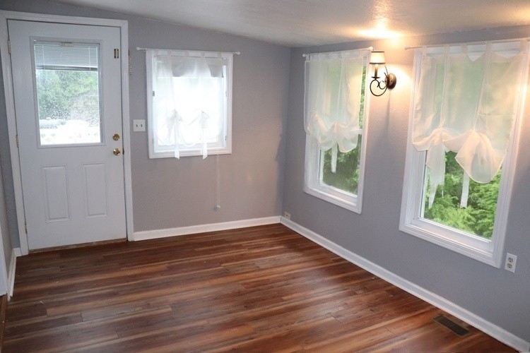 209 Church Street Dover, TN 37058 - Photo 16 of 16 a view of an empty room with wooden floor and a window